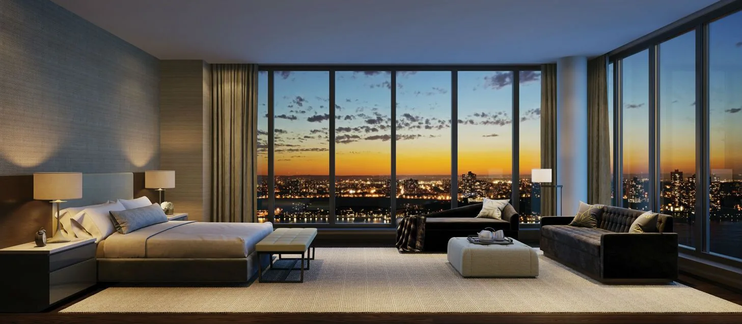 Dormitorio principal con ventanal panorámico sobre la ciudad al anochecer