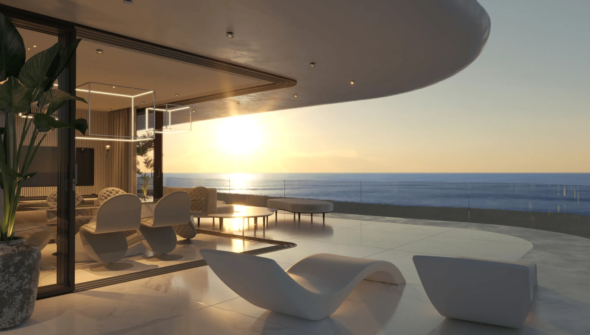 Salón abierto a una terraza sobre el mar al atardecer
